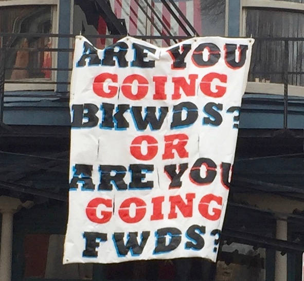 Handmade sign reading Are you going bkwds? or are you going fwds?