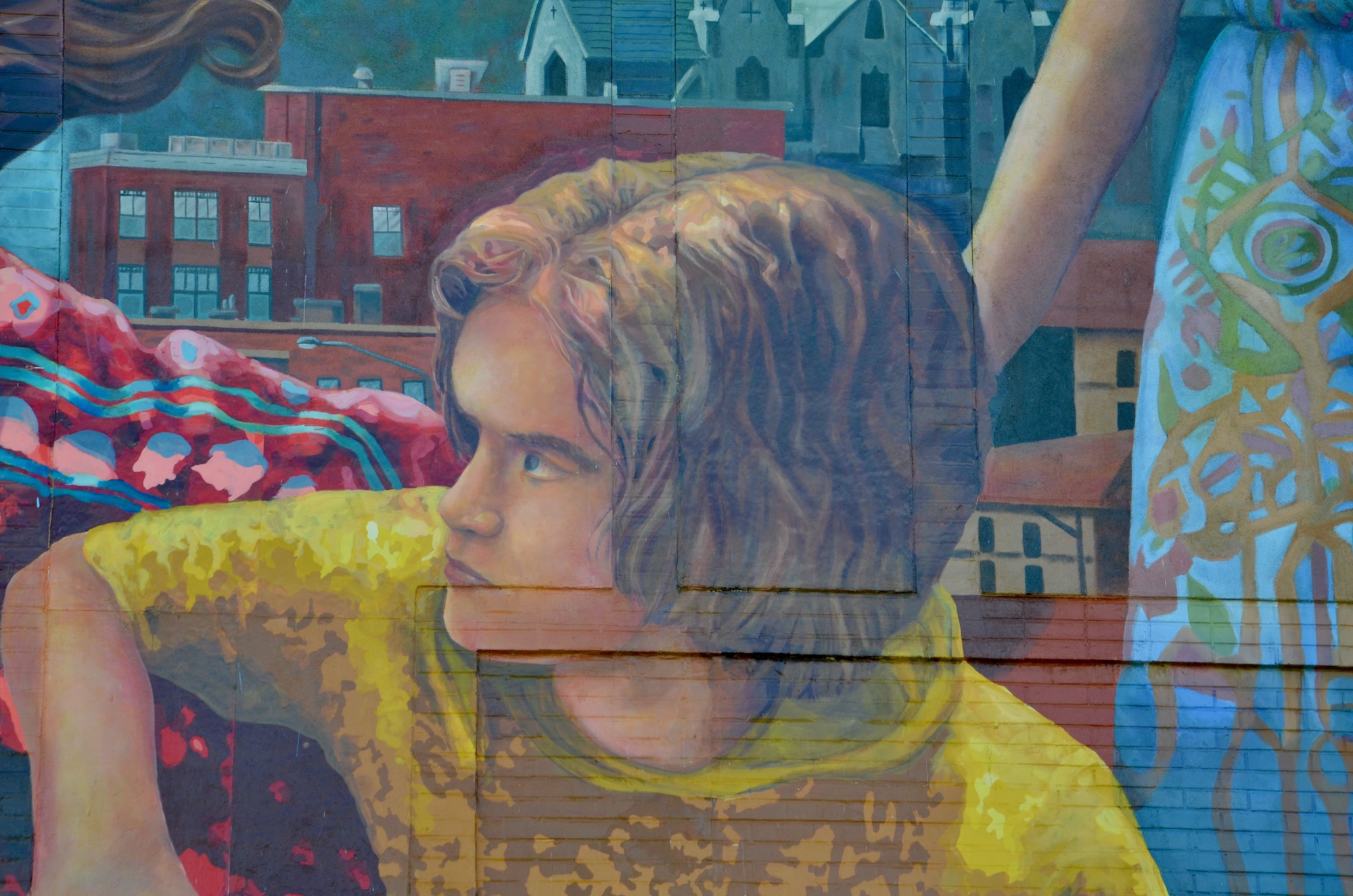 Thoughtful young man pictured in a mural.