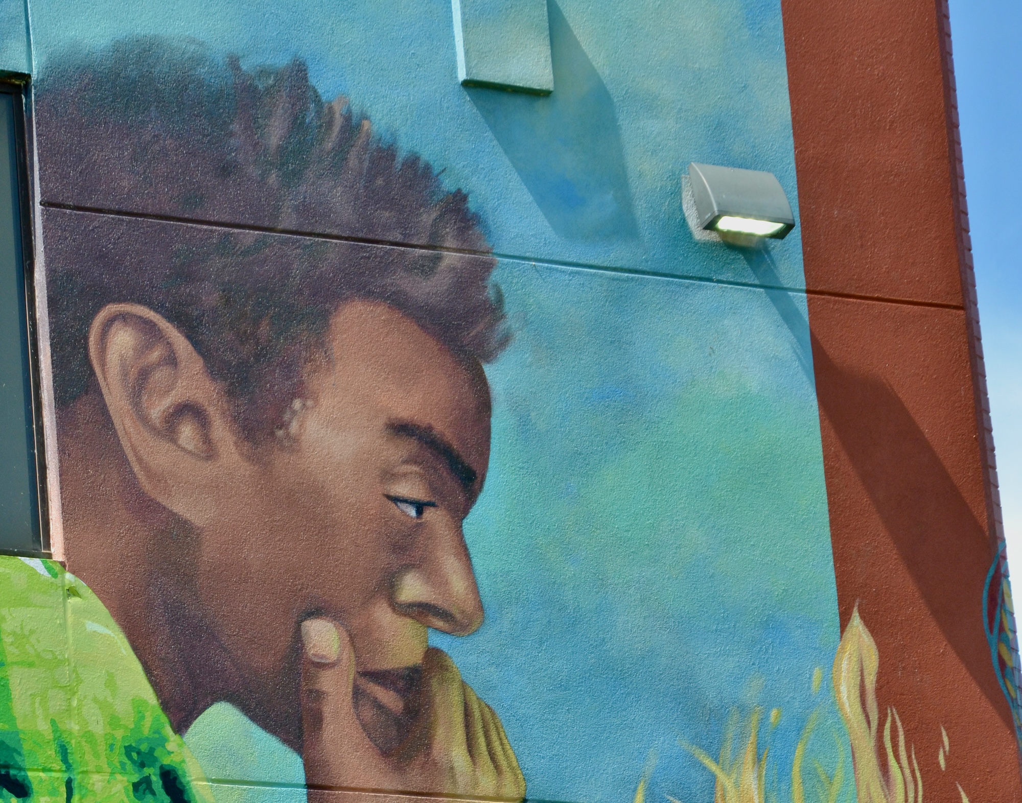 Thoughtful young man pictured in a mural.