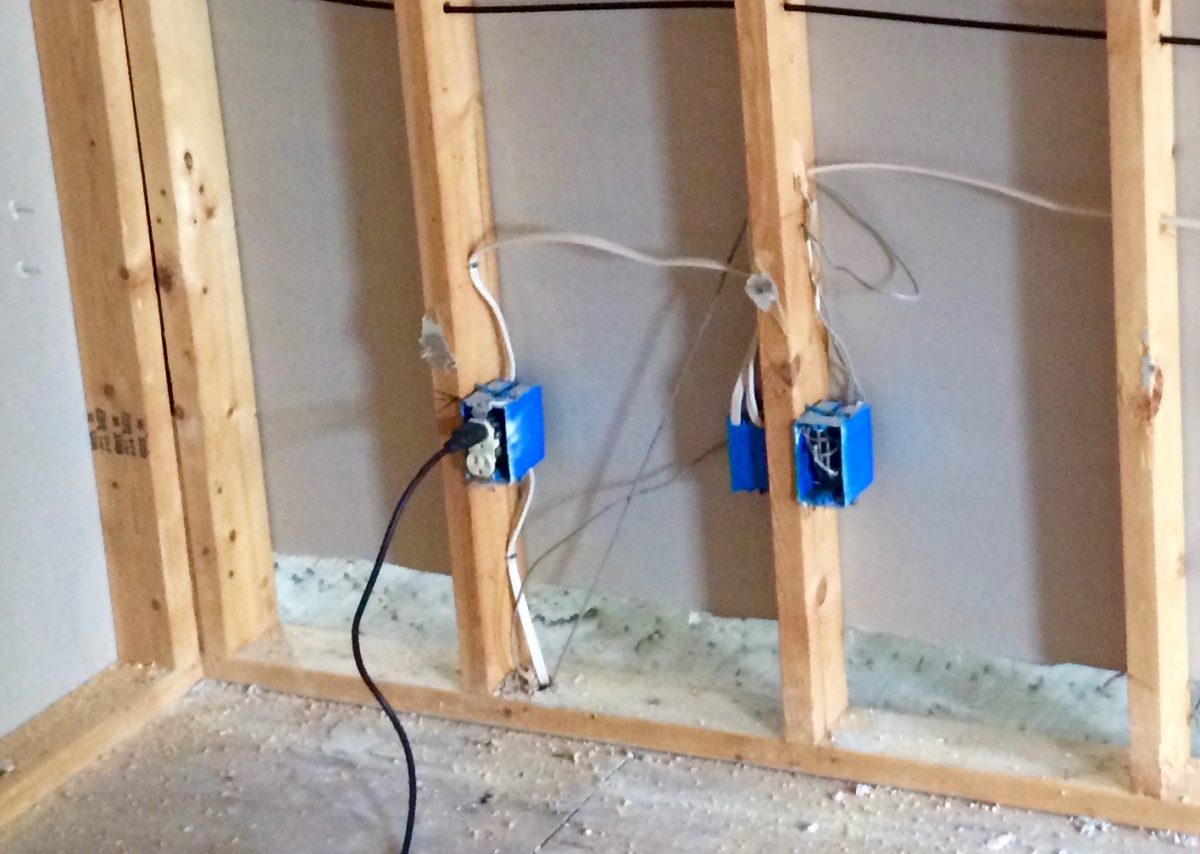 Electric boxes and outlets hung on studs.
