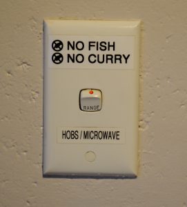 Switch for a microwave labeled No fish, no curry.