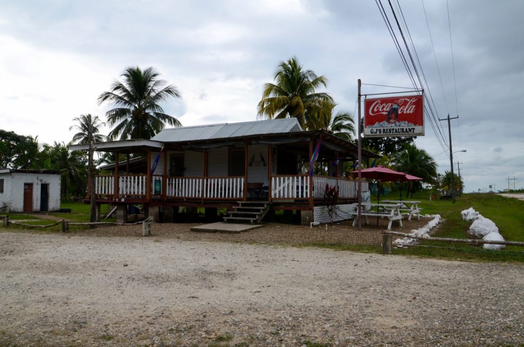 Small roadside restaurant with a porch, and a large Coca Cola sign