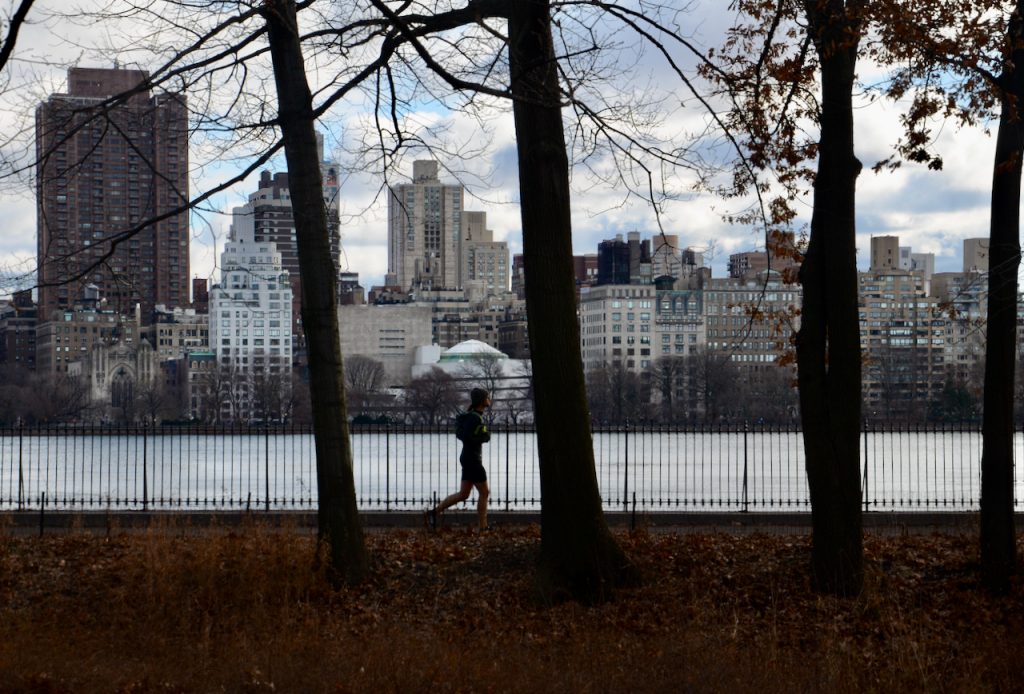 A jogger around JKF resevoir with the Gugenhiem in the background.