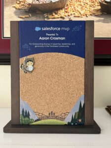 My MVP Award. Blue at the top with my name printed on it. An a cork-board in the middle for annual pins from Salesforce. I just have the one for this year.