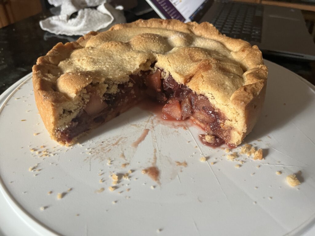 Apple pie-like pastry, with a large wedge already missing.