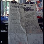 A cloth banner with a message in Russian and English calling for restraint in the Balkins.