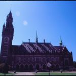 Peace Palace, which is a large simple looking building with large clock tower on the left.
