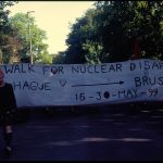 Banner nearly as wide as two road lanes which reads: 2000 Walk for Nuclear Disarmament The Hague --> Brussels 16-30 May 99