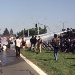 Water cannon firing on a group on the ground while other watch.